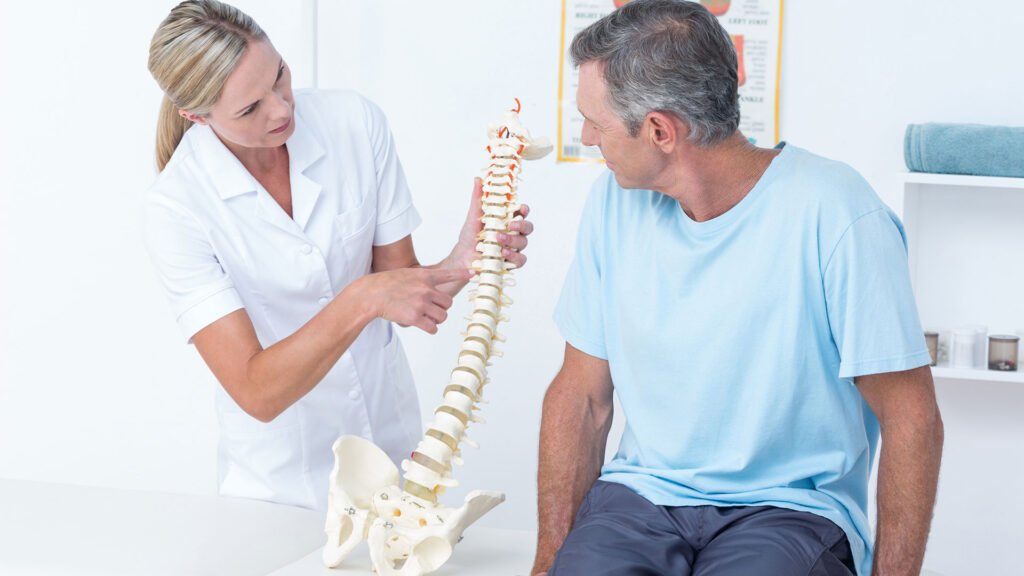 Doctor Showing Spine Model To patient