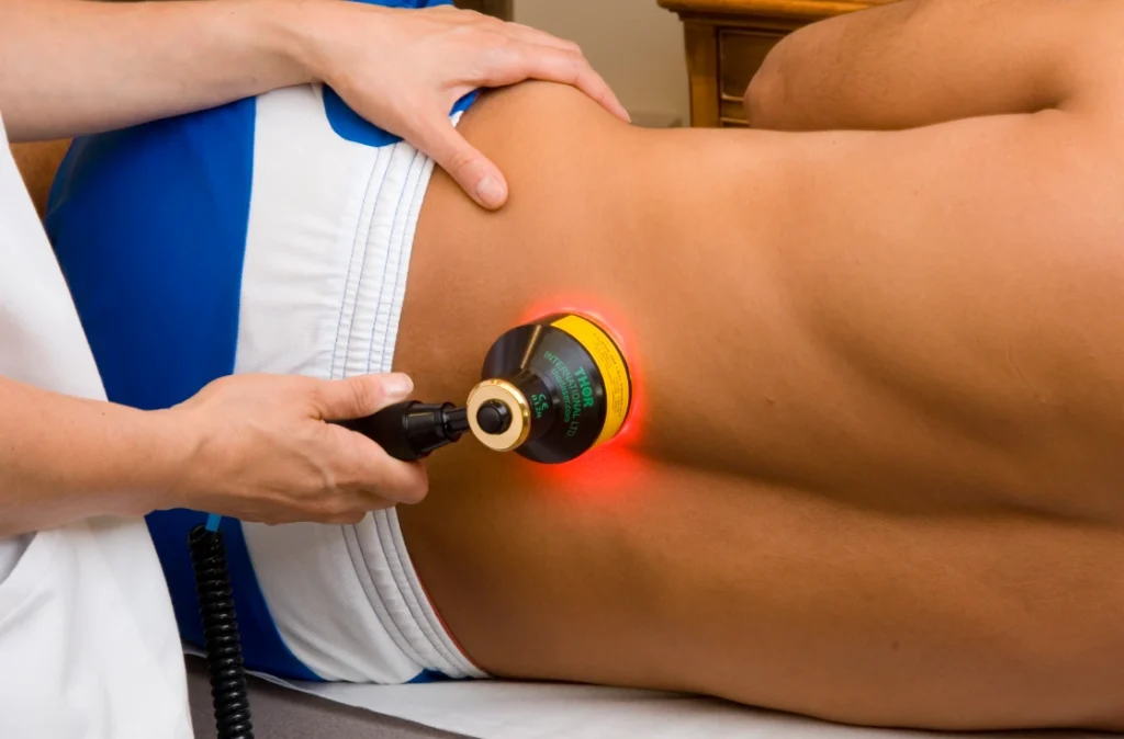 laser therapy on lower back of patient