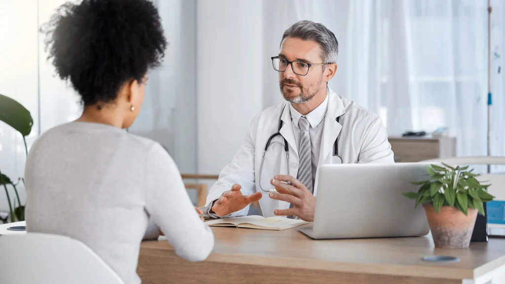 Doctor consulting with a patient in a modern medical office.