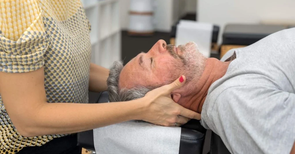 elderly-man-receiving-gentle-neck-adjustment-from-a-chiropractor-during-therapy-session